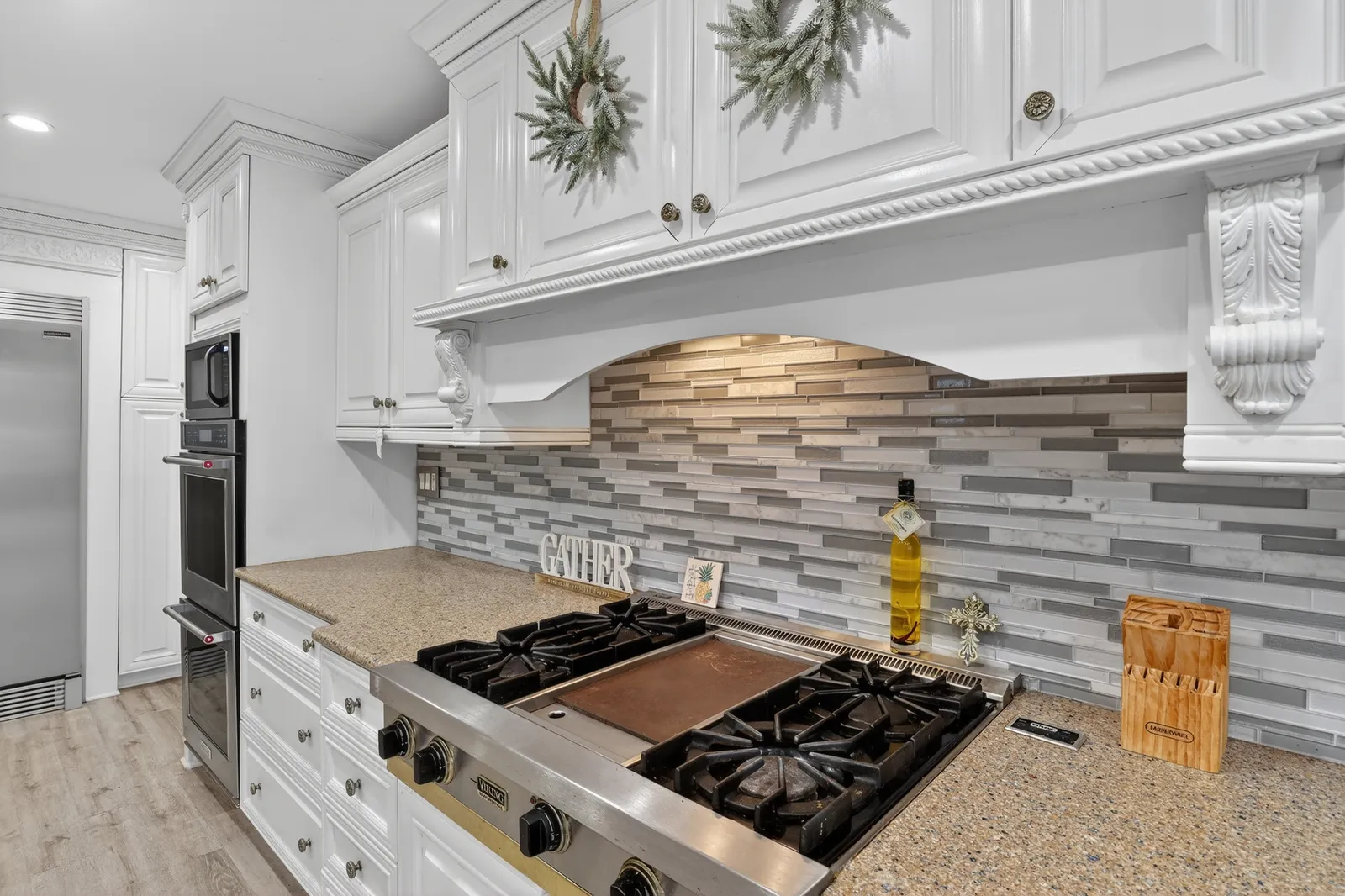 White kitchen with gas range and tile backsplash in a Fort Myers home