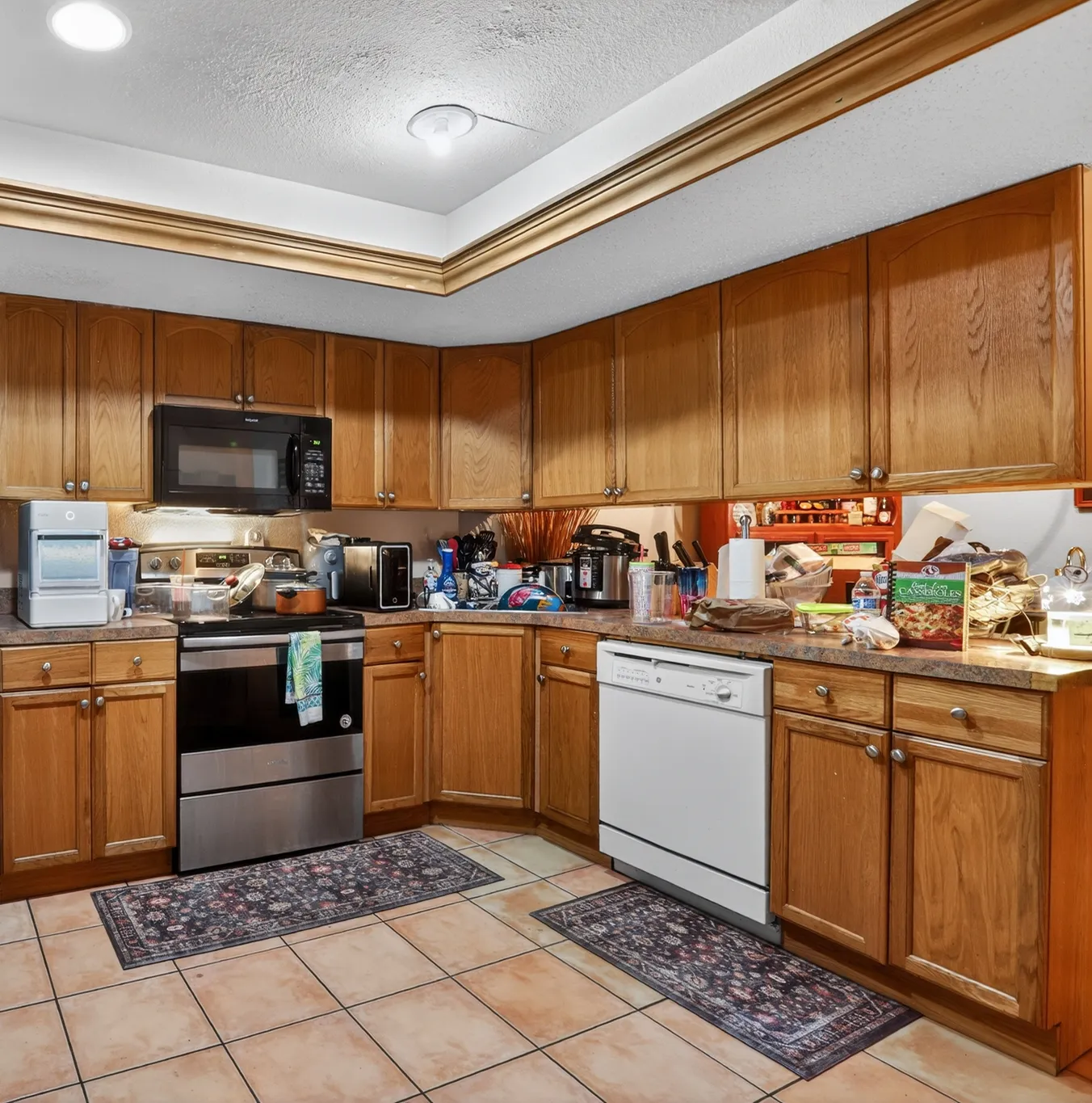 Lived-in kitchen with oak cabinets in a Kissimmee home