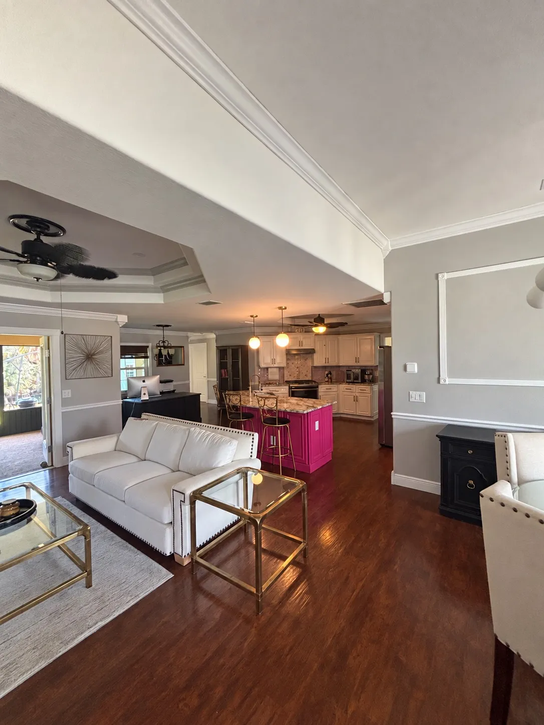 Open living room and kitchen with wood floors in a Port Charlotte home