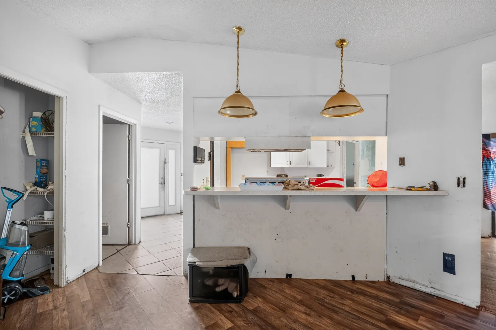 Worn living area and breakfast bar inside a Spring Hill home before repairs